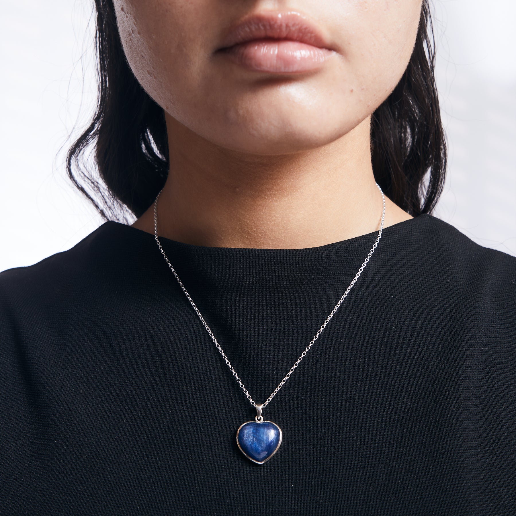 Heart shaped Kyanite pendant from brazil with sterling silver chain on model