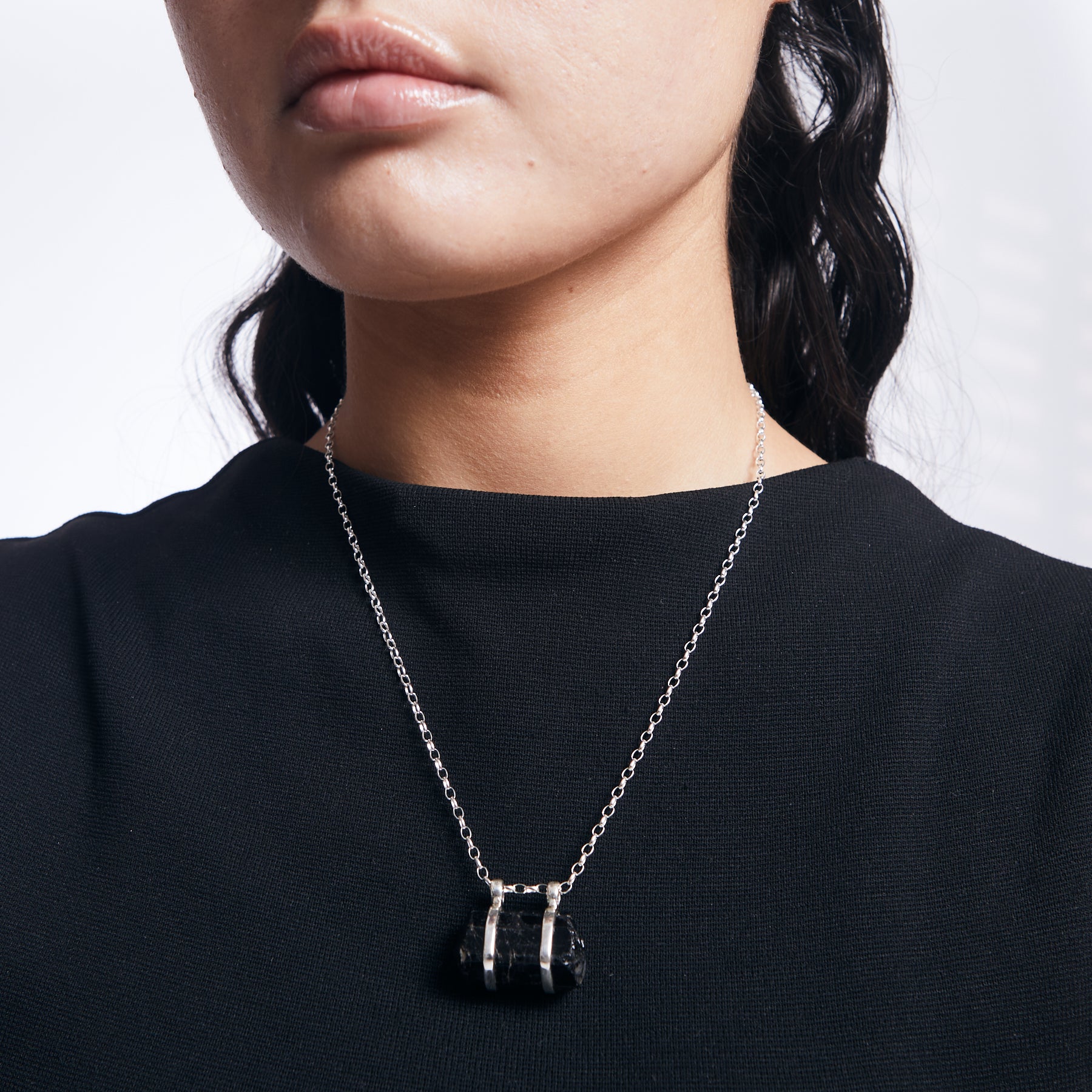 Black Tourmaline rough with double belt and a fixed hook on sterling silver chain on model