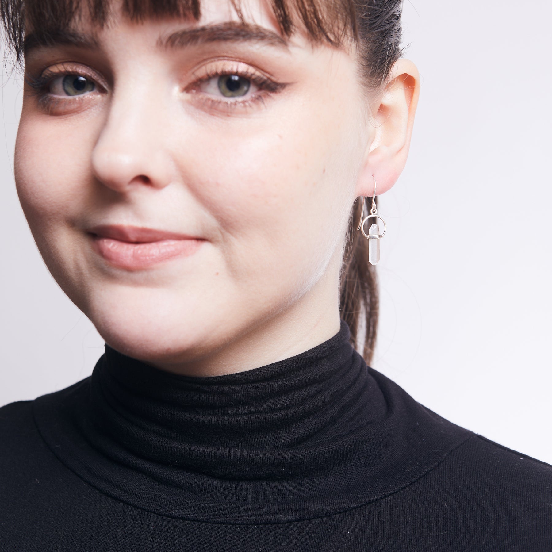 clear quartz pencil with belt setting halo drop earring on model