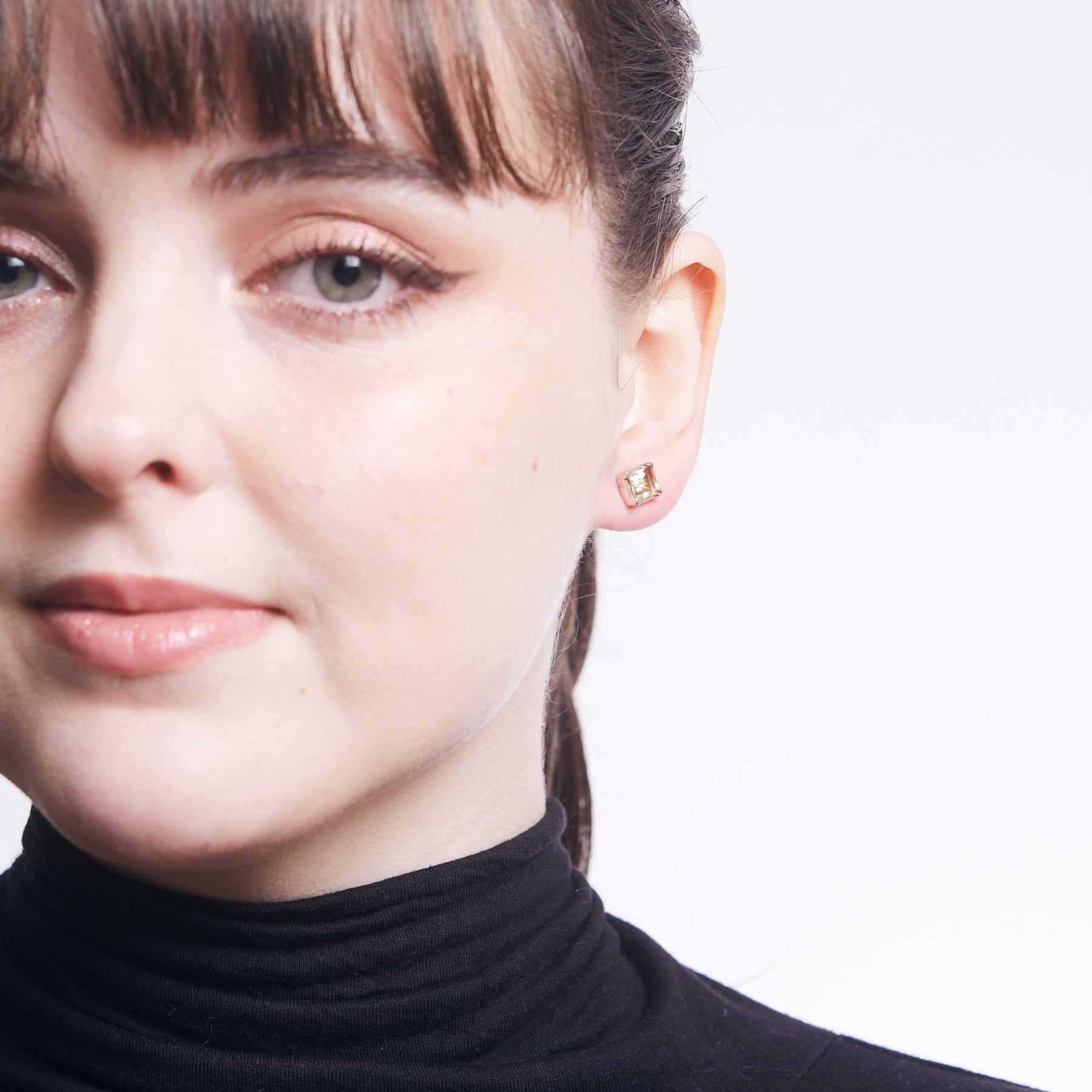 Citrine square faceted stud earrings with claw setting on model