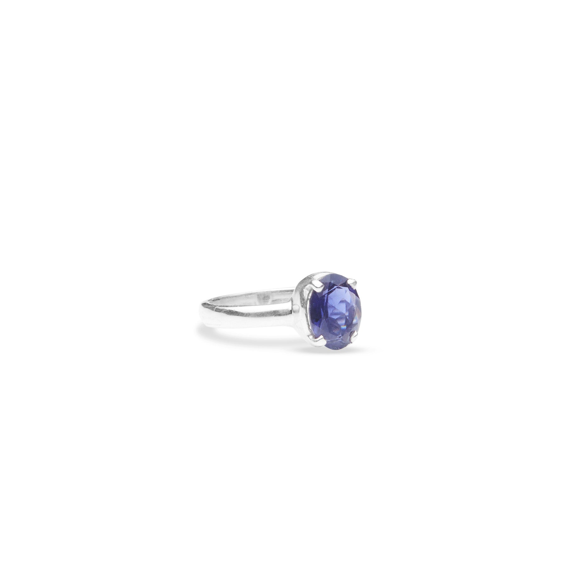 Iolite oval faceted ring with thin band and claws side angle