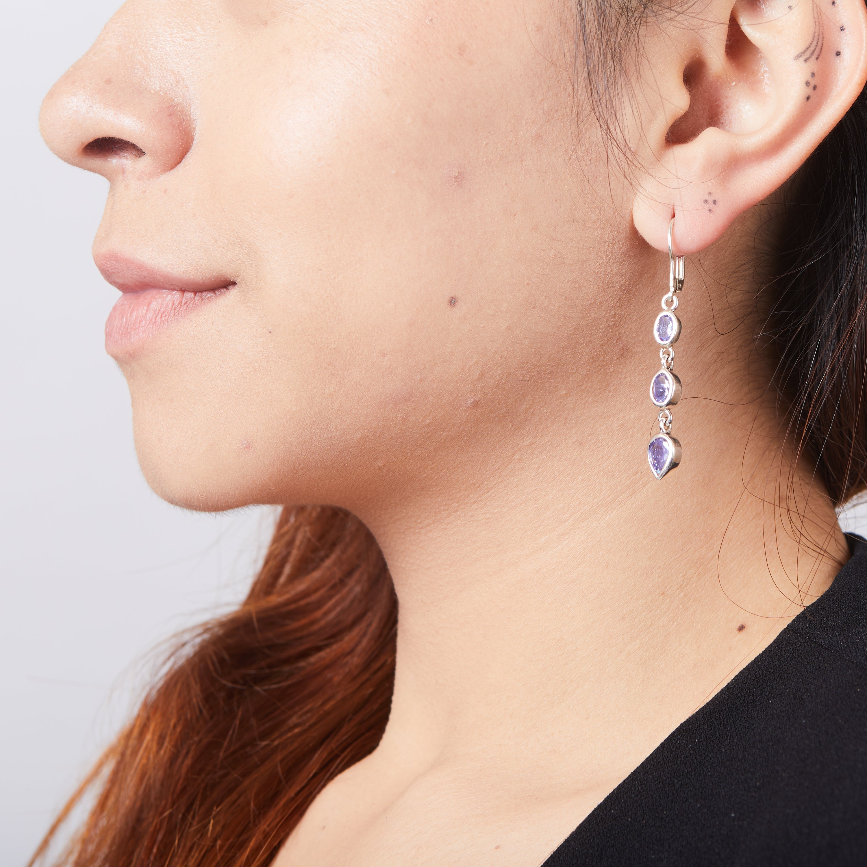 Tanzanite oval and teardrop faceted drop earrings on model