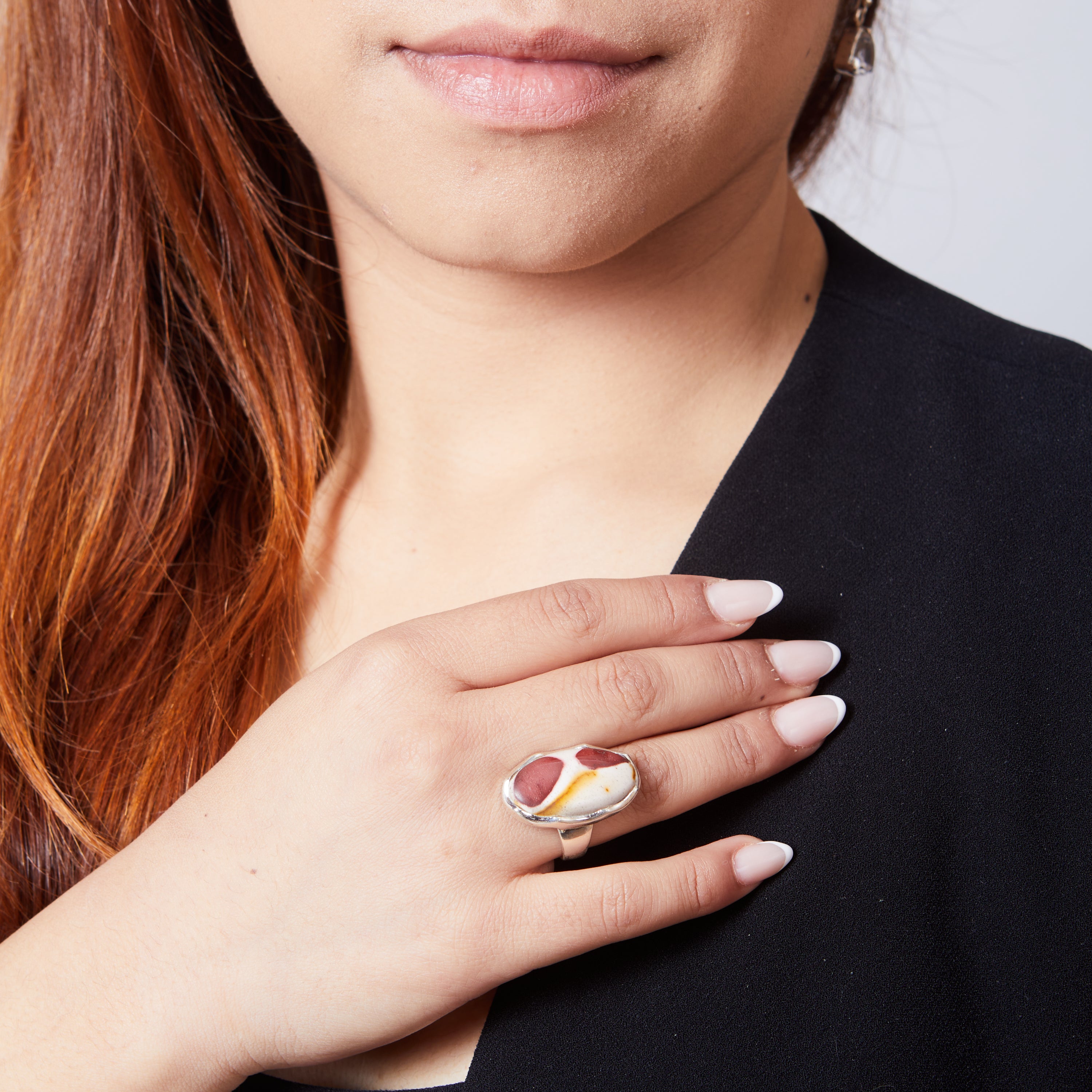 Mookaite oval cabochon ring with wave bezel on model