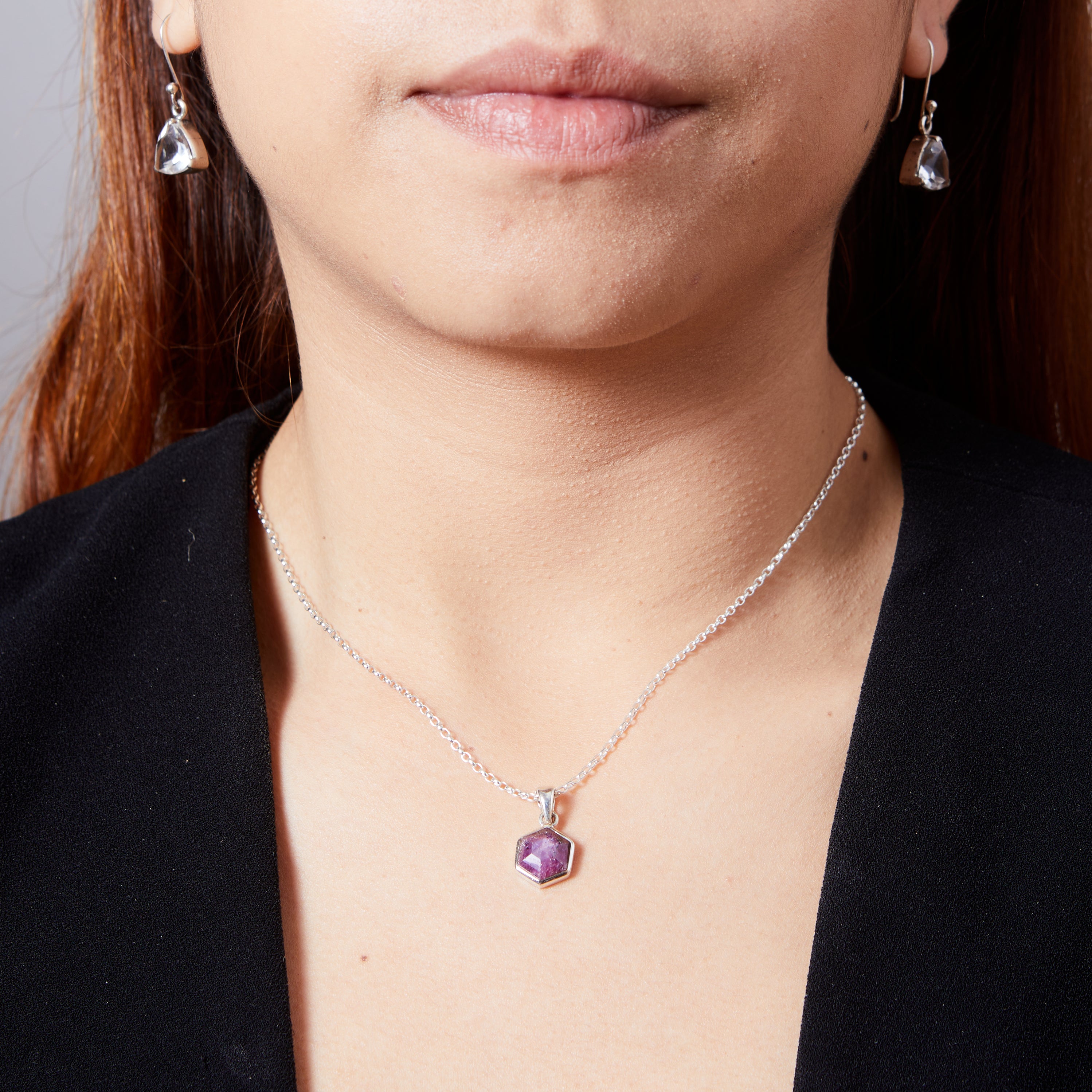 Ruby faceted hexagon pendant with bezel setting on model