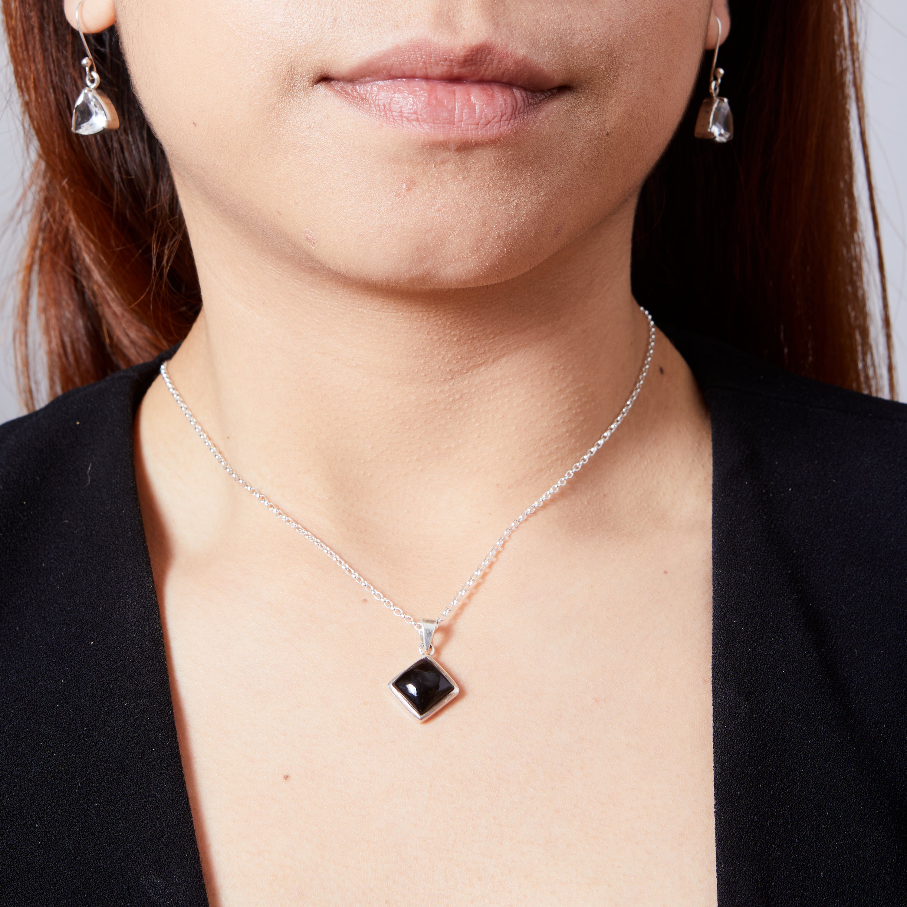 Black onyx cabochon diamond set pendant  on model 