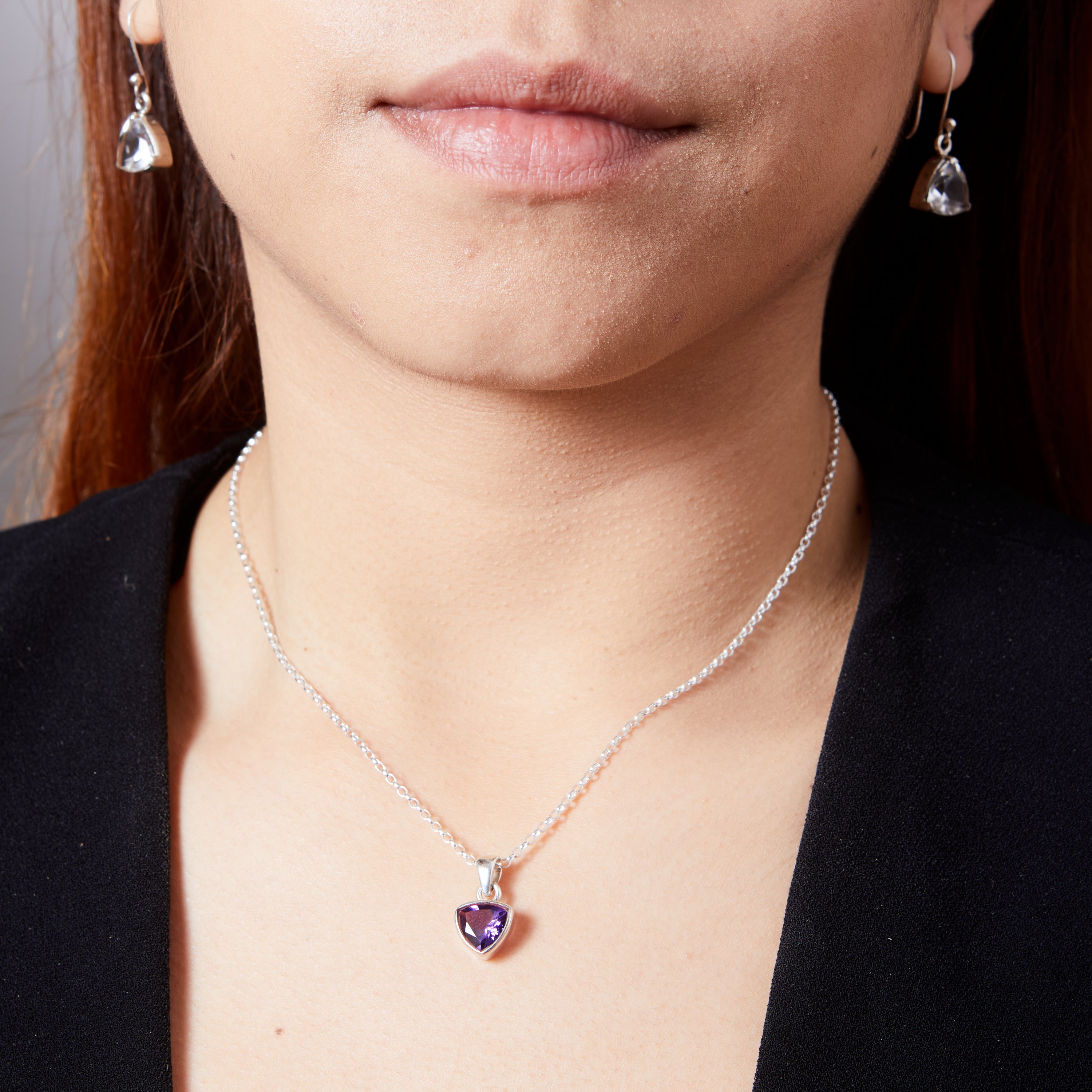 Amethyst faceted inverted triangle with bezel set pendant on model