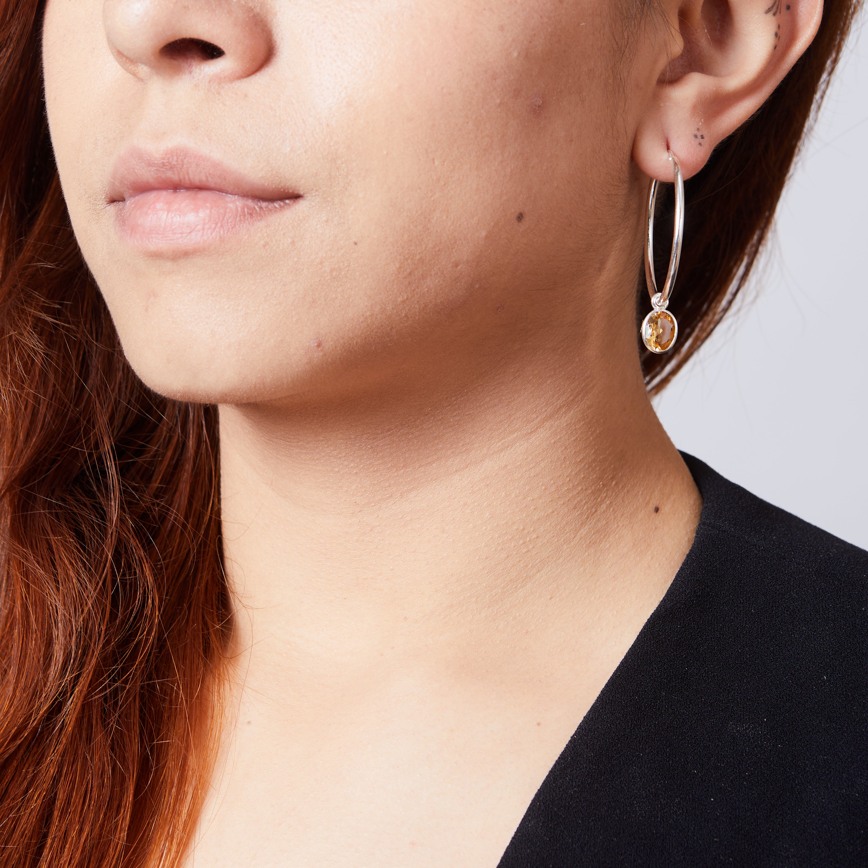 Citrine faceted oval bezel set hoop attachments on model