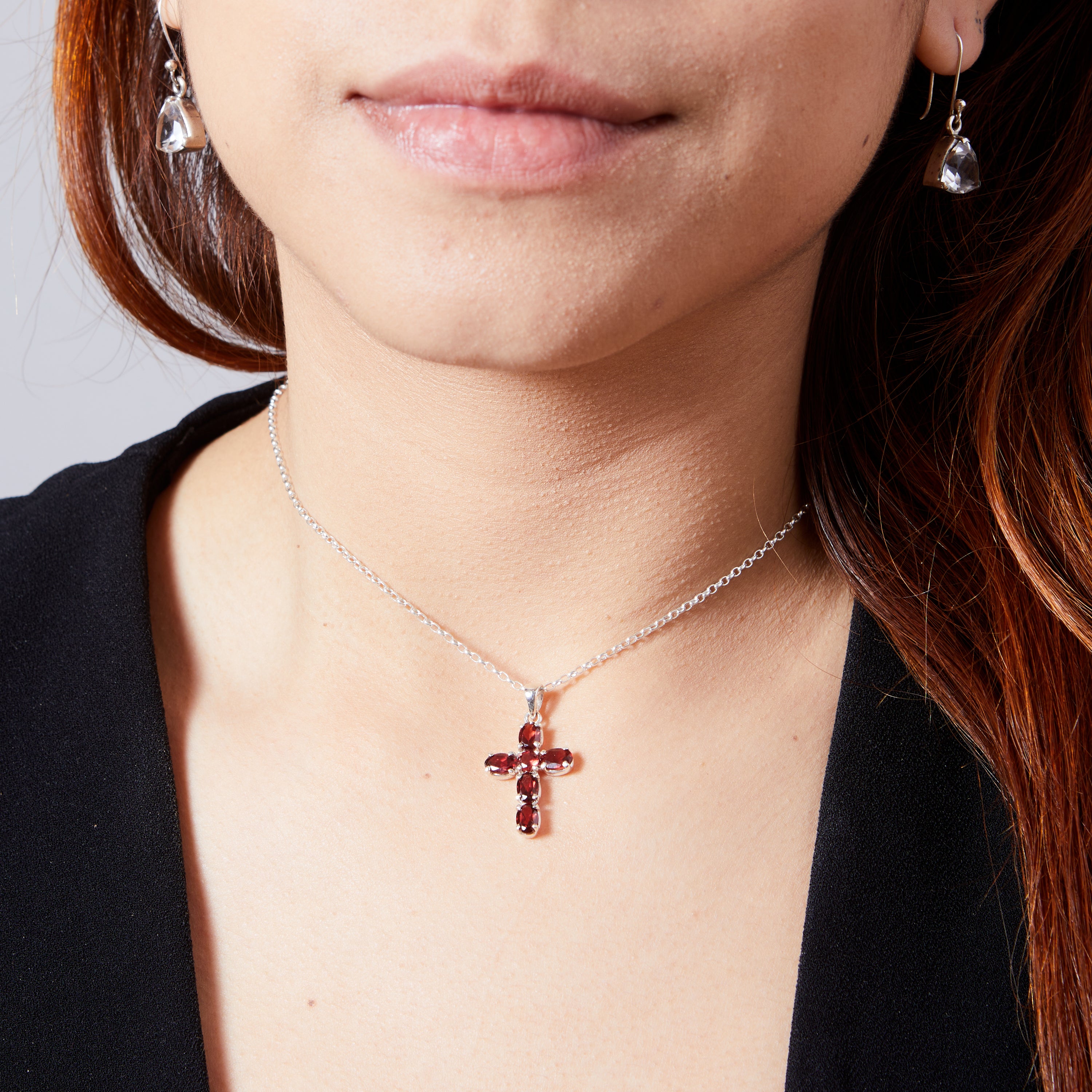 Garnet faceted claw set cross on model