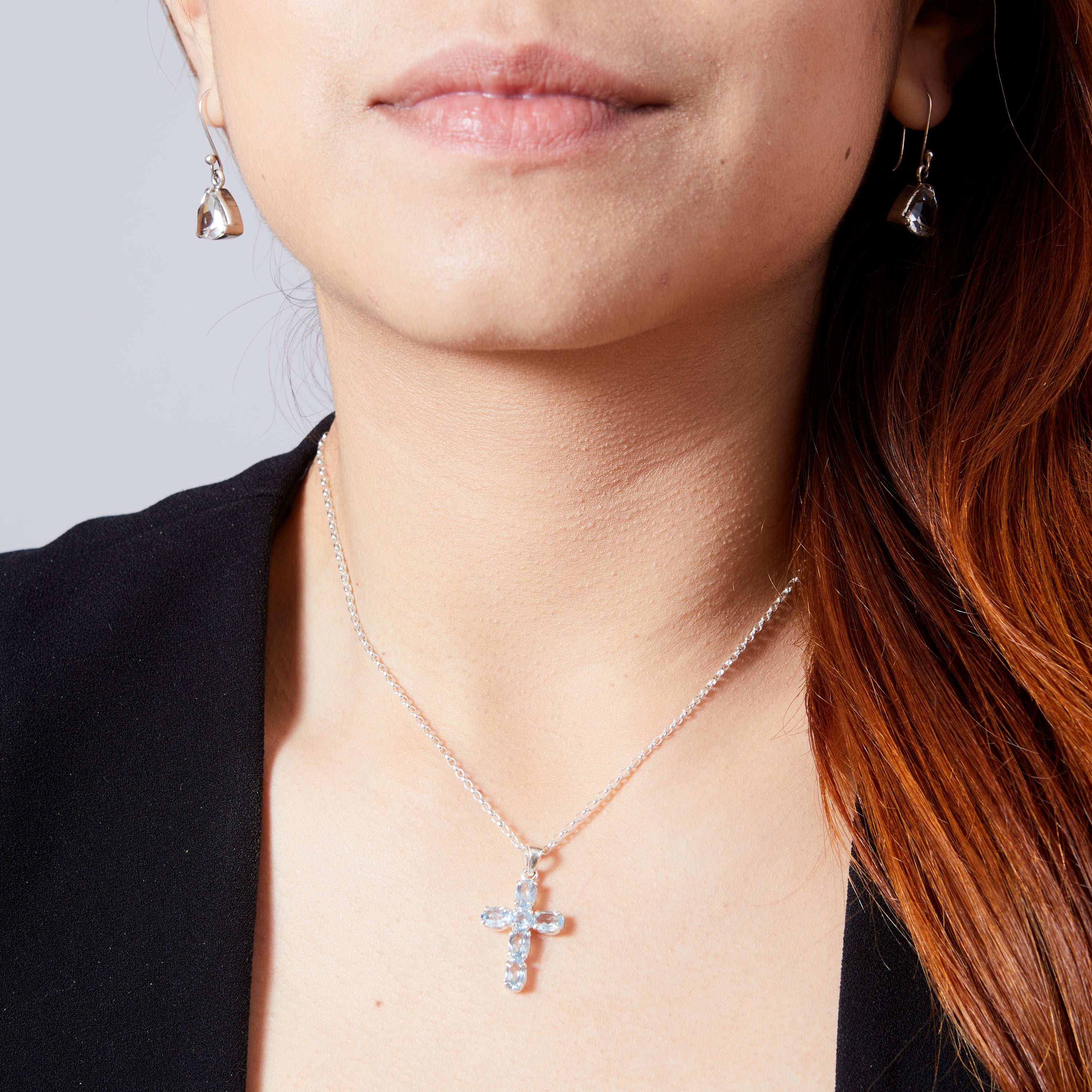 Blue Topaz faceted claw set cross  on model