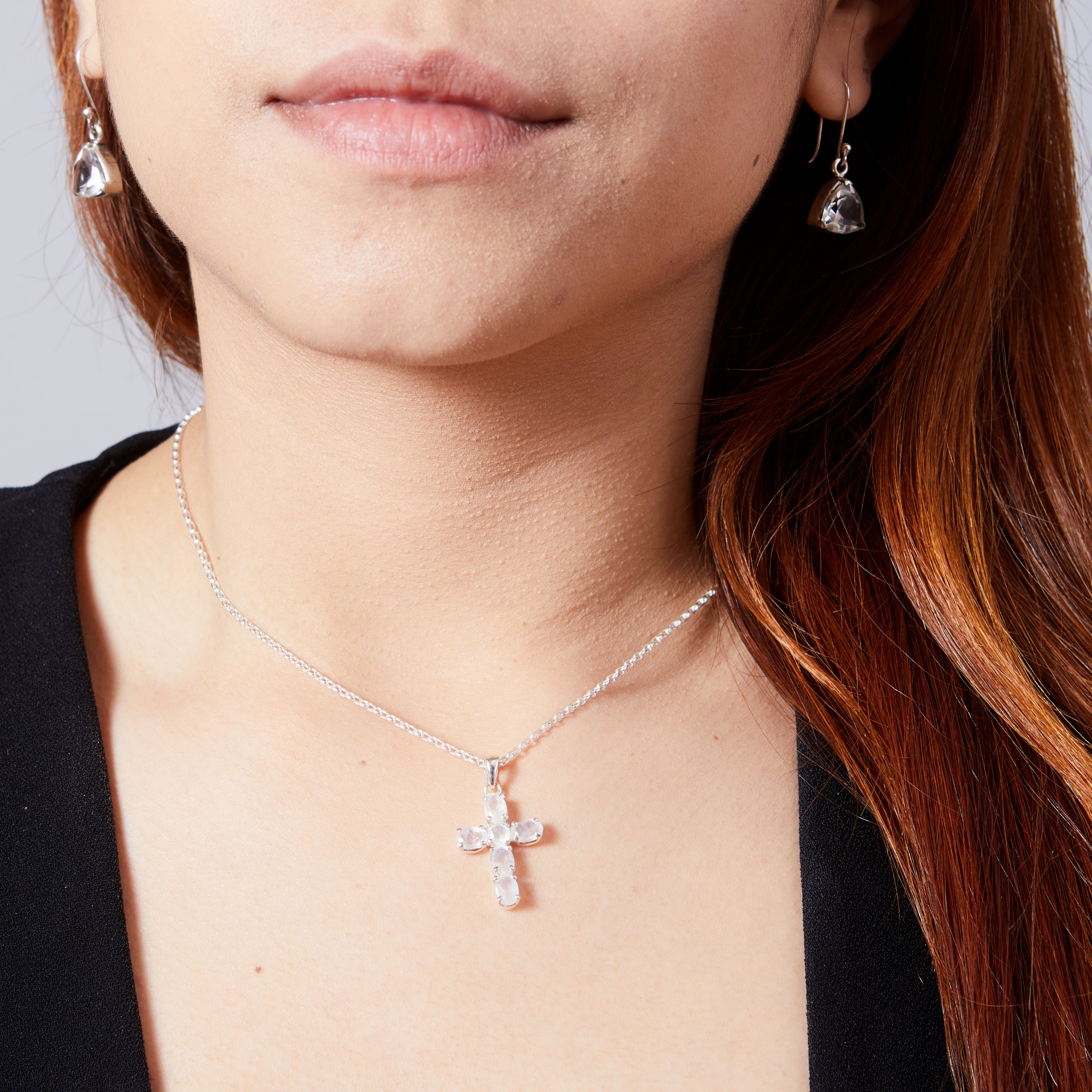 Rainbow Moonstone faceted claw set cross on model