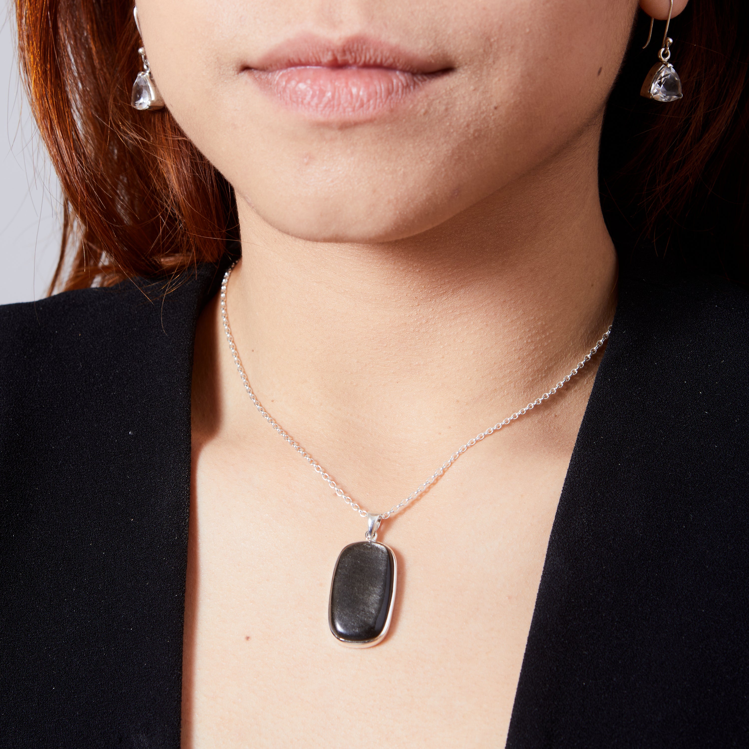 Silver Sheen Obsidian cabochon oval bezel set pendant  on model