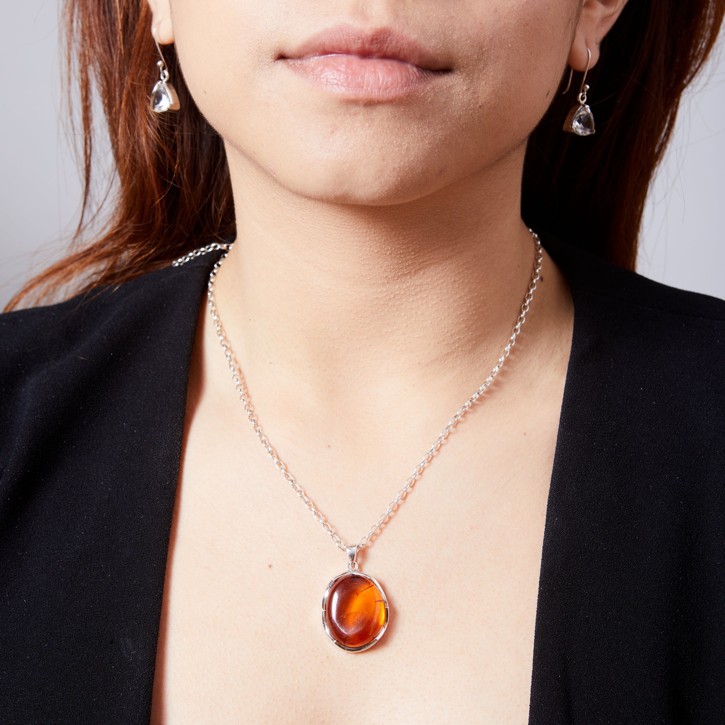 Amber cabochon freeform with wave bezel pendant on model