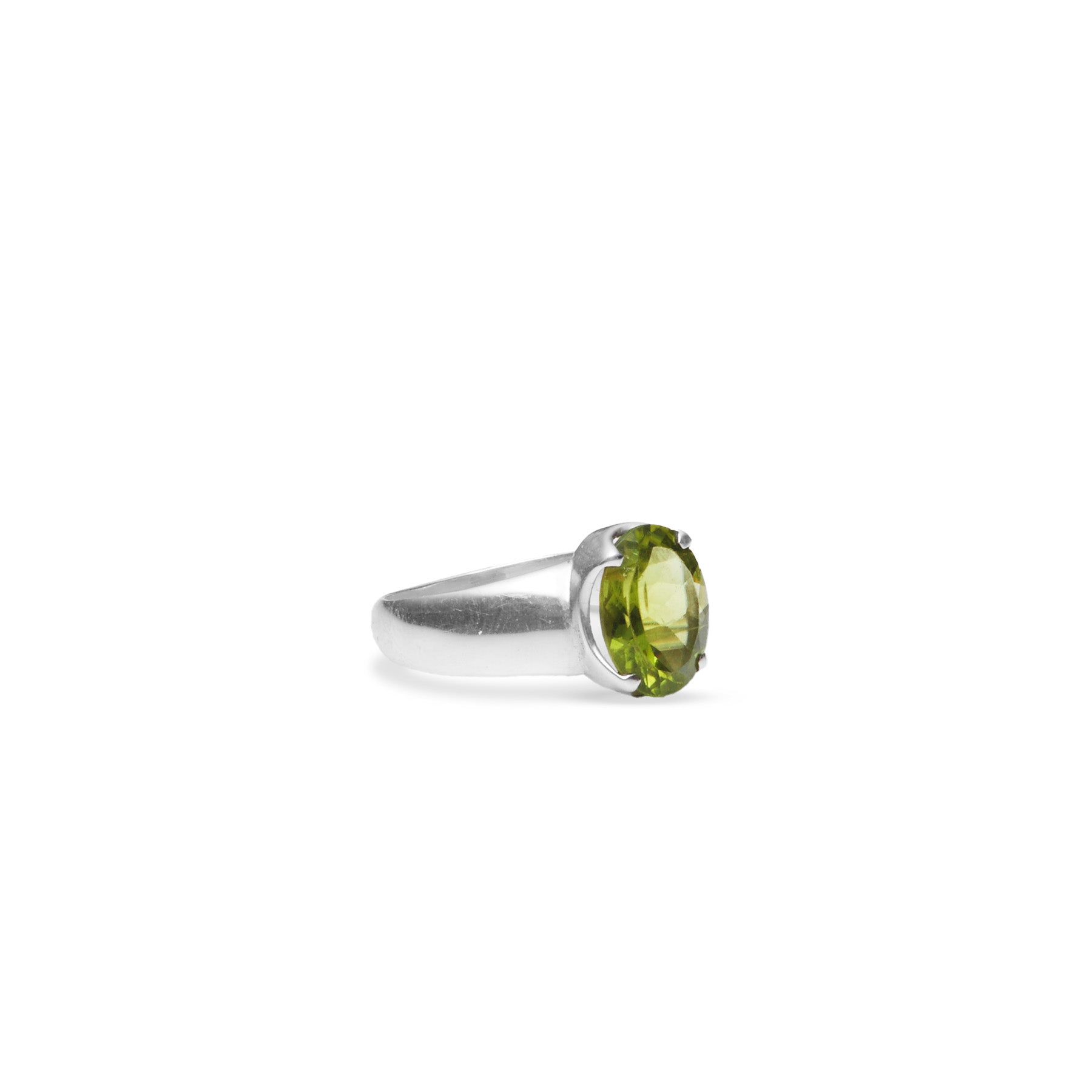 Peridot oval faceted ring with claw setting and thick a-line band