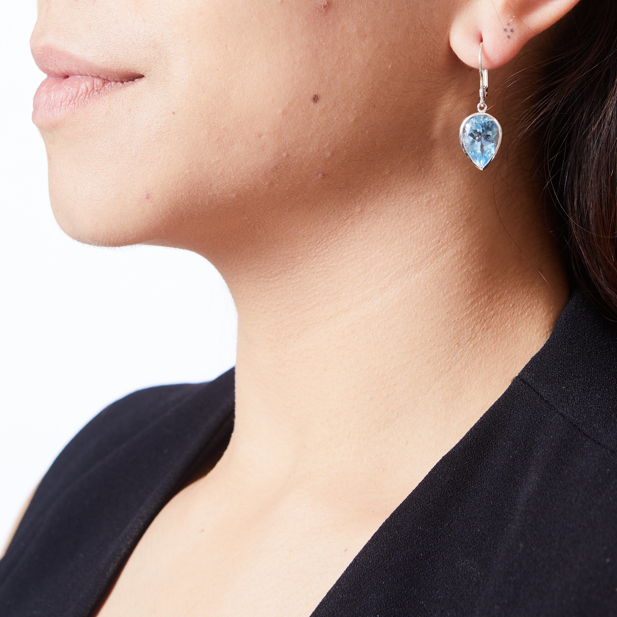 Blue topaz inverted teardrop faceted clasp earrings on model