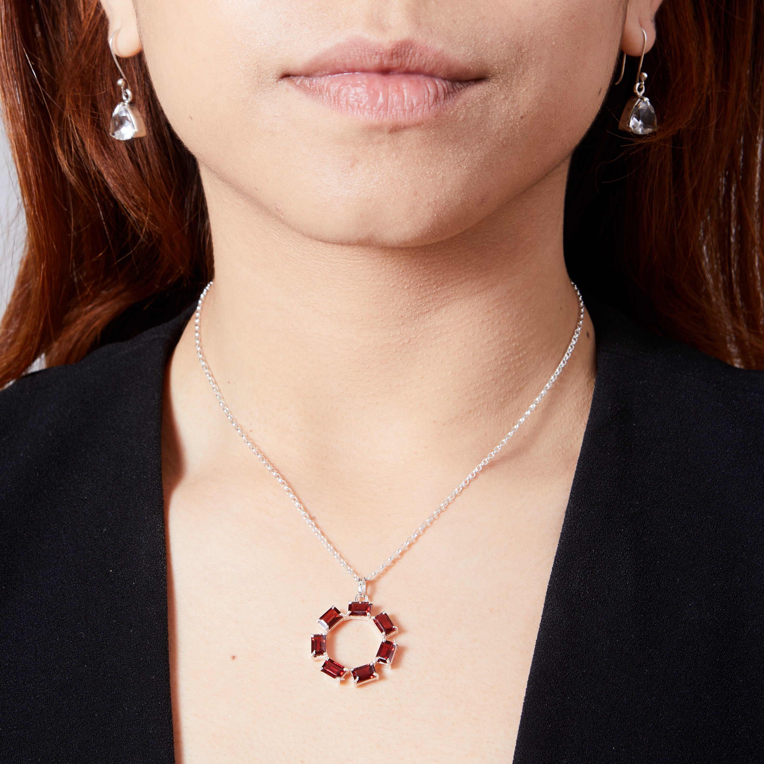 Garnet rectangle faceted claw set round pendant on model