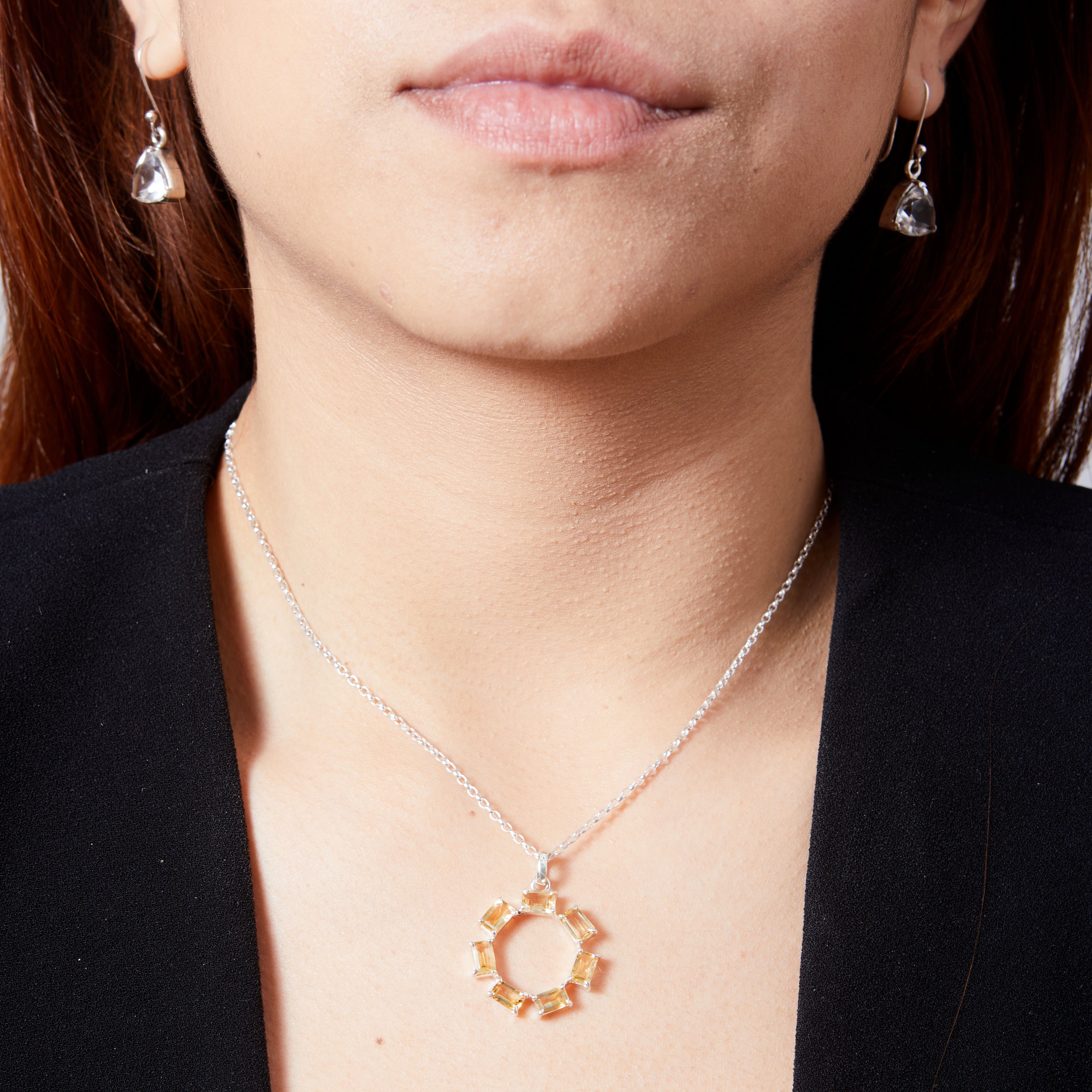 Citrine rectangle faceted claw set round pendant on model