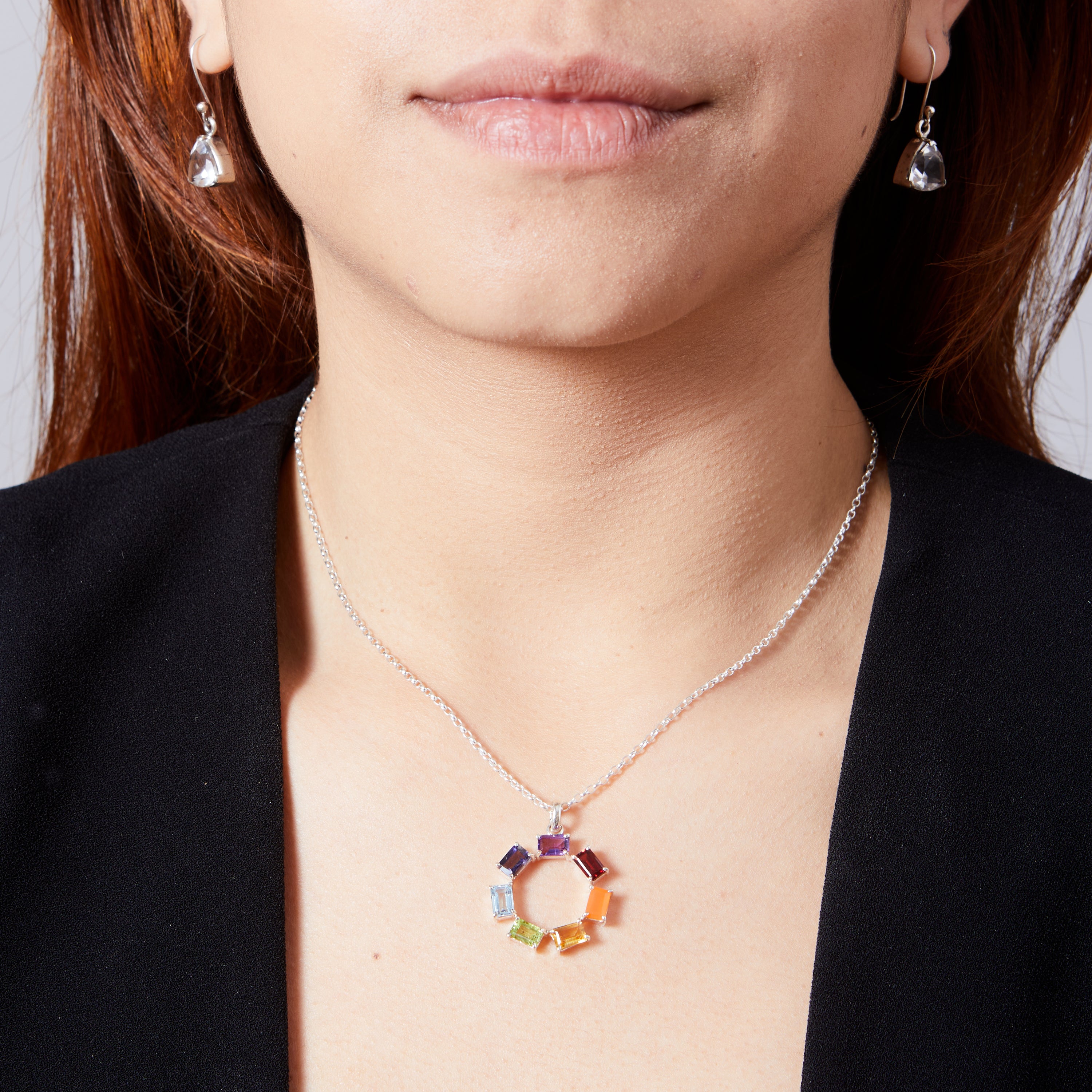 Chakra rectangle faceted claw set round pendant on model