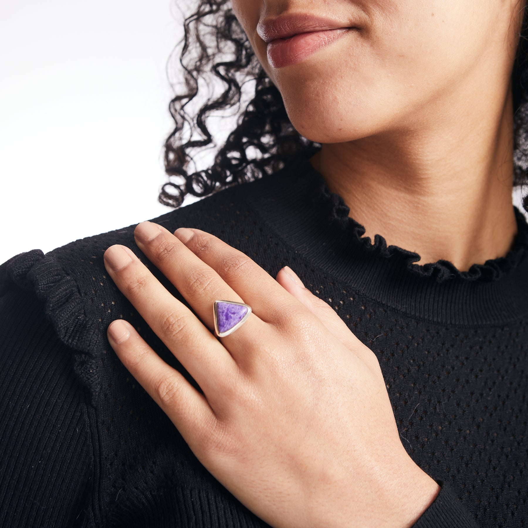 Sugilite triangle ring with sterling silver bezel on model 