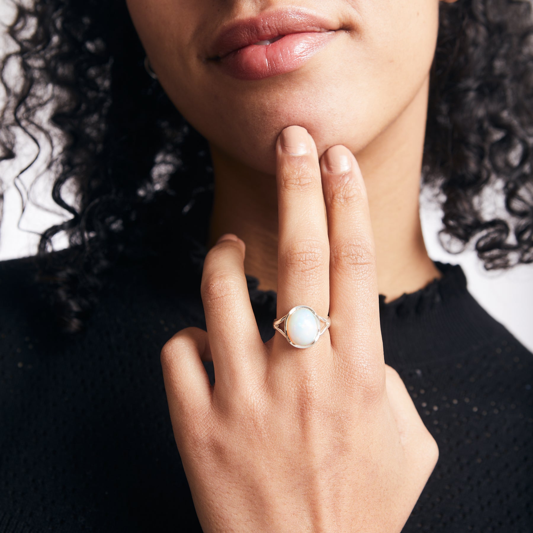 Precious oval Opal ring with wave bezel and sterling silver split band on model