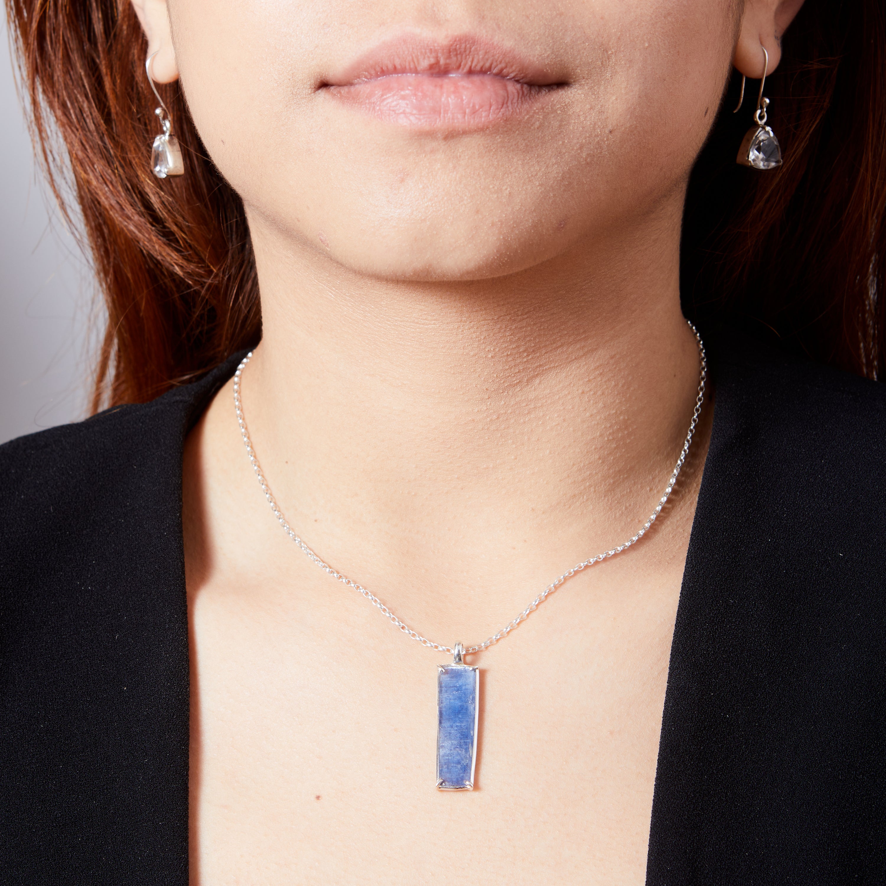 Kyanite cabochon rectangle freeform claw set pendant on model