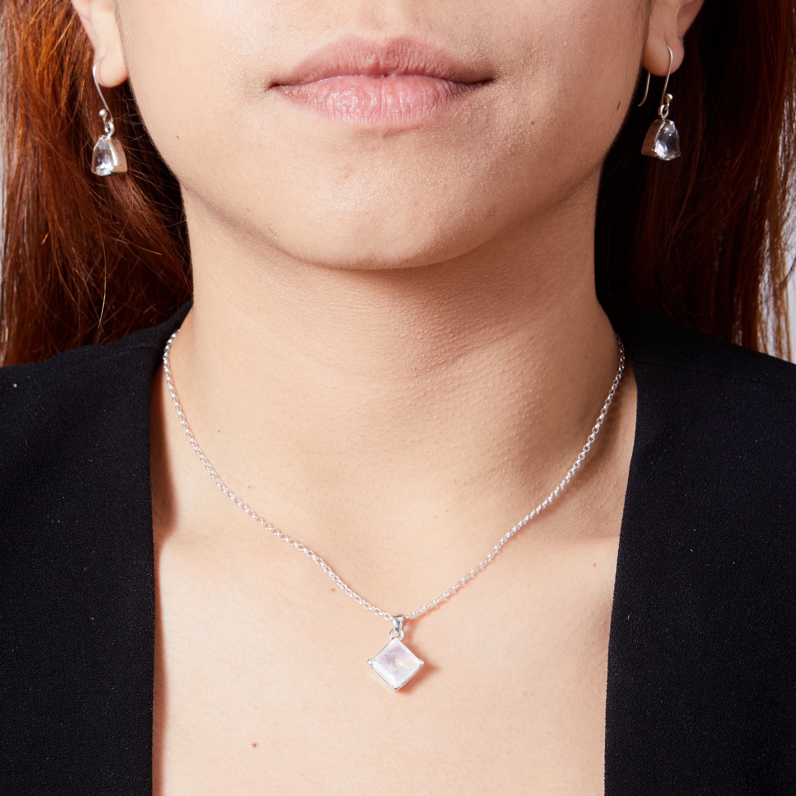 Rainbow Moonstone square diamond set faceted pendant with clamp setting on model