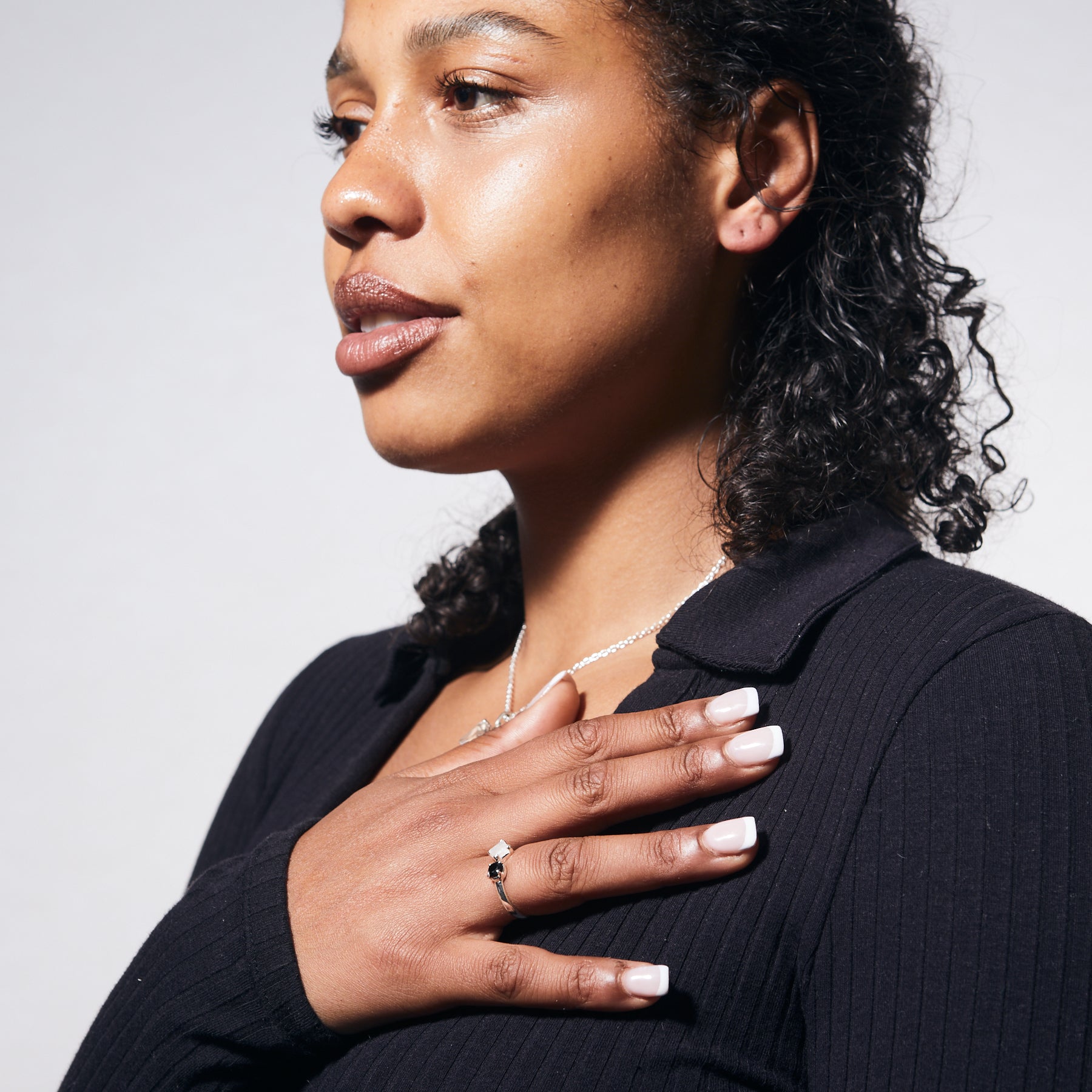 Rainbow Moonstone square and onyx round faceted claw set ring on model