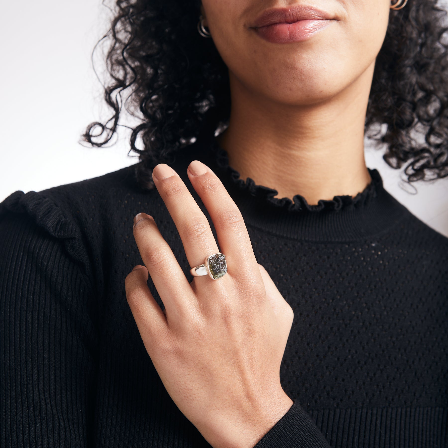 Moldavite rough freeform ring with thick sterling silver band on model