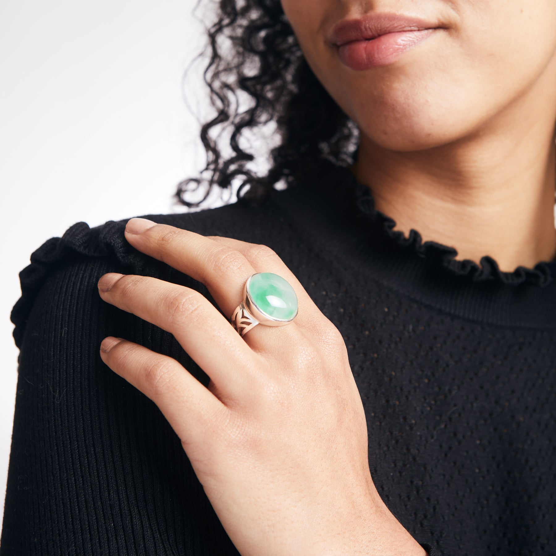 round jadeite cabochon ring with sterling silver filigree band on model