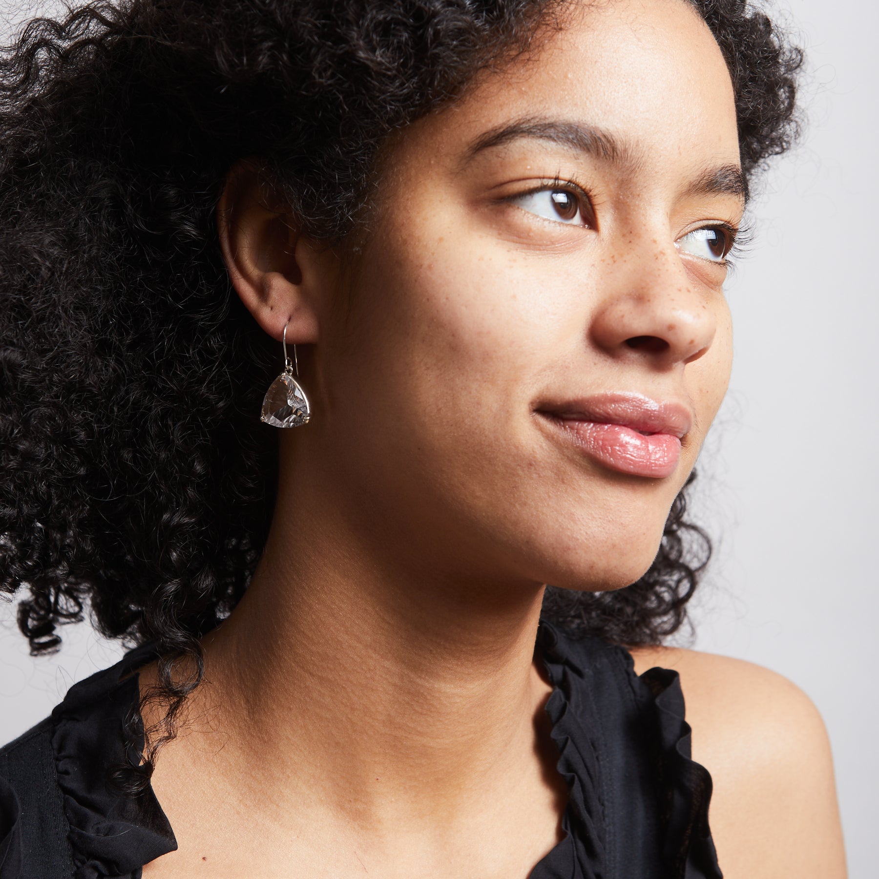 clear quartz faceted triangle drop earrings on model