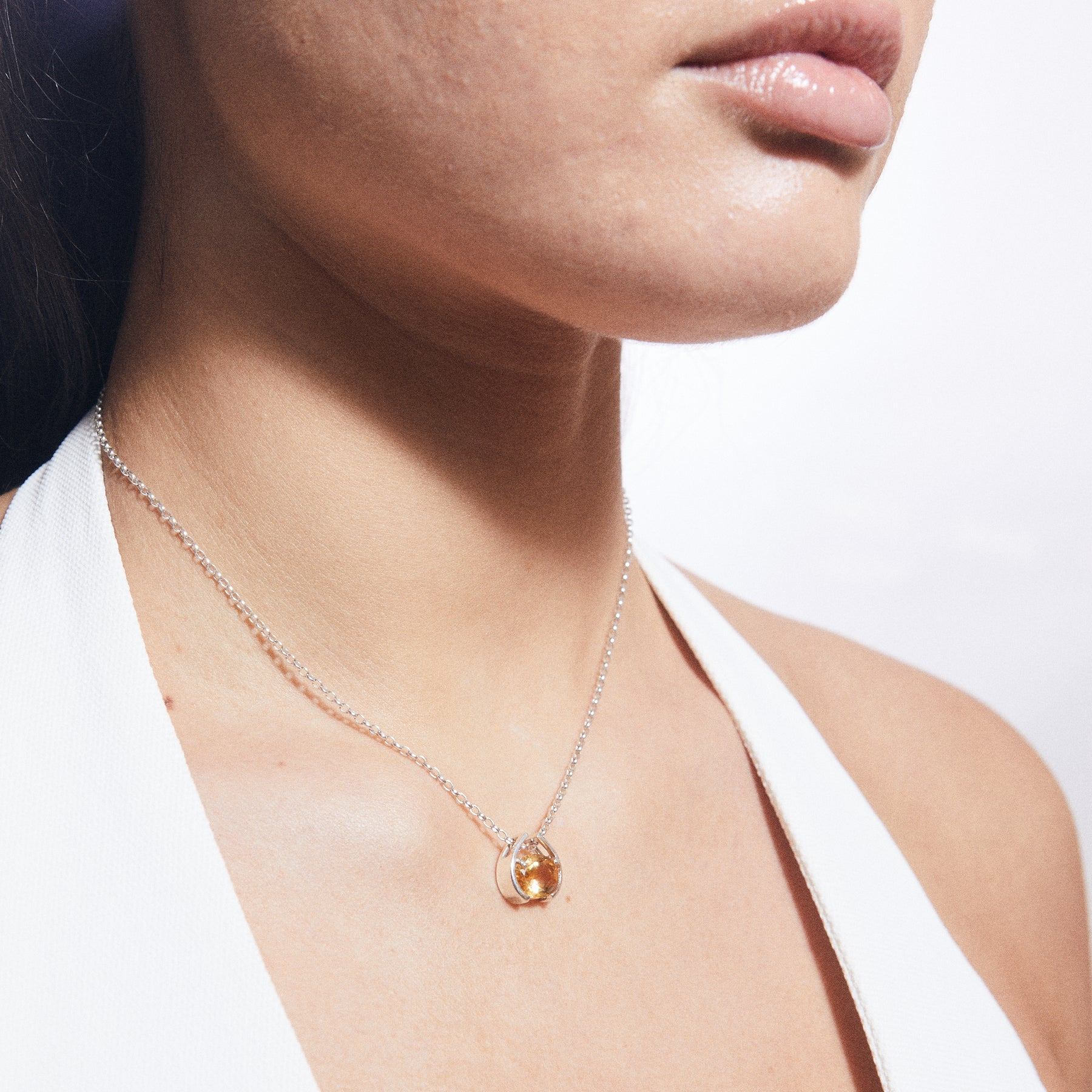 Citrine faceted oval pendant with claw and clamp bezel on model