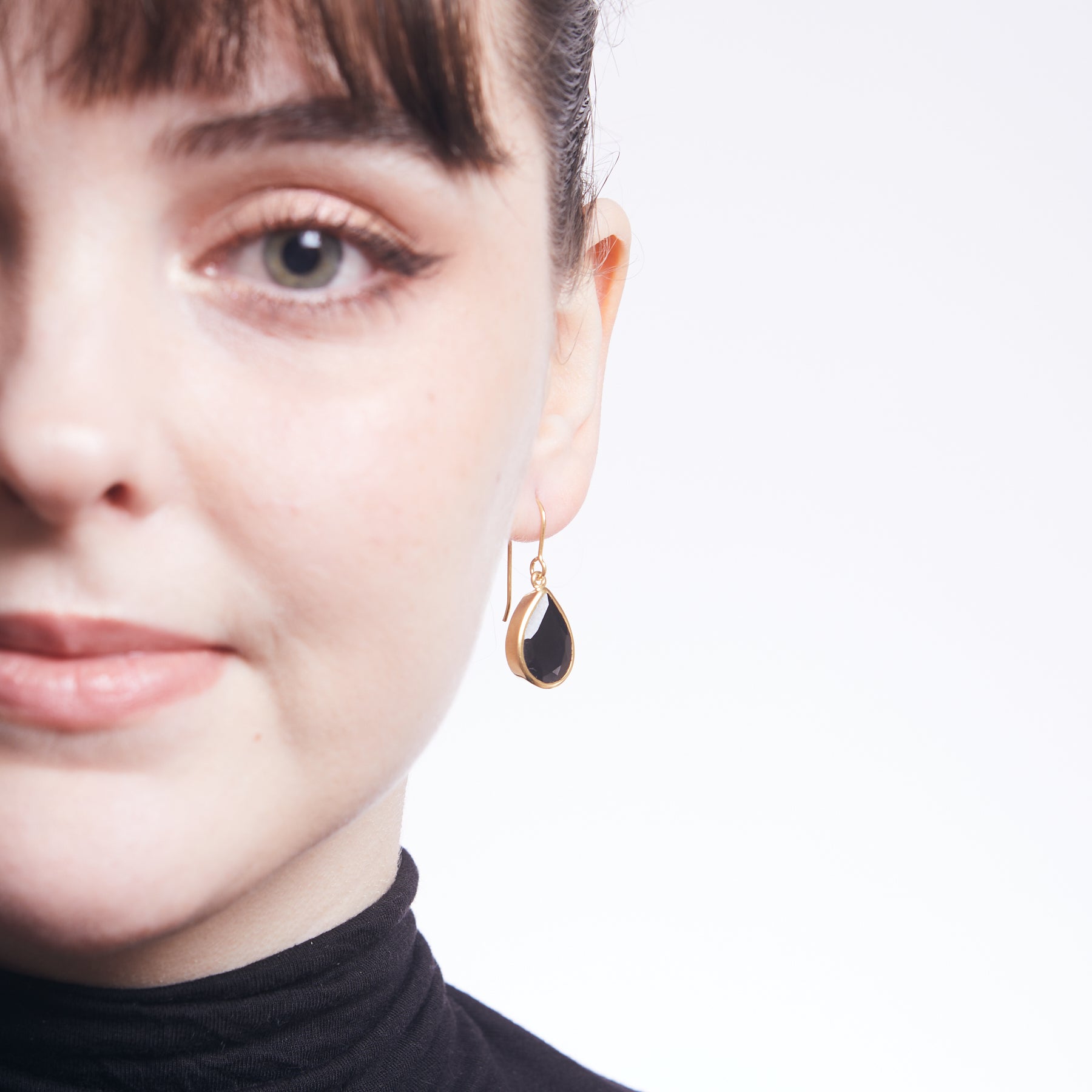 Black Onyx faceted teardrop drop earrings  in vermeil gold on model