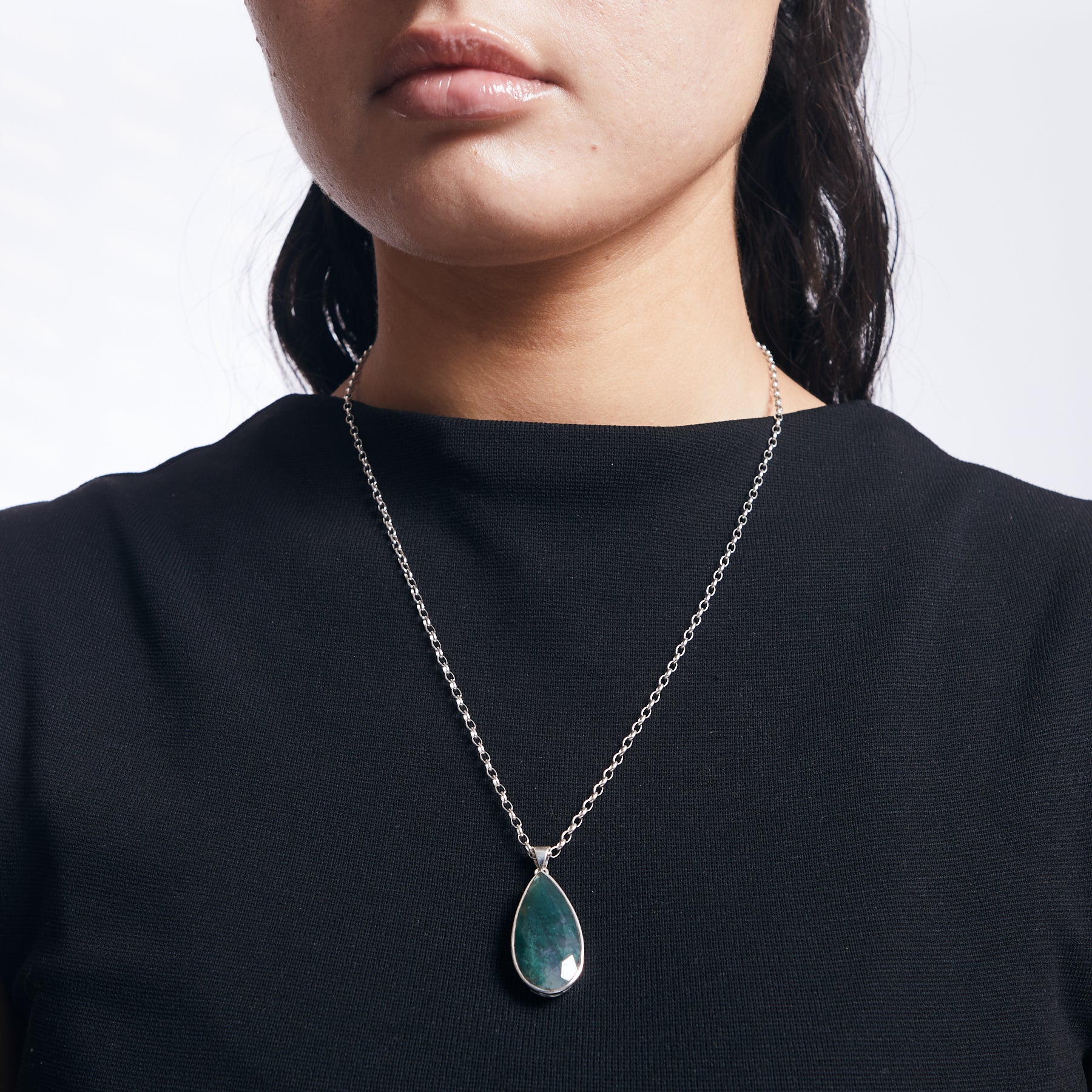 Moss Agate teardrop pendant with filigree bezel setting on sterling silver chain on model